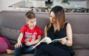 child and adoptive parent reading