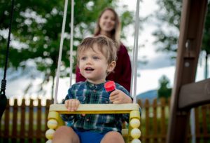 Toddler on swing with mum