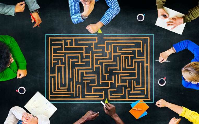 professionals looking at maze