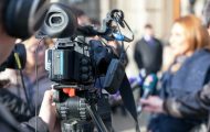 Journalists interviewing woman