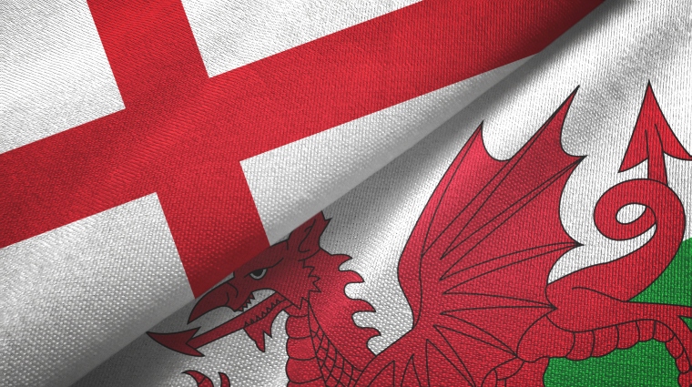 The England flag and the Welsh flag lying next to each other