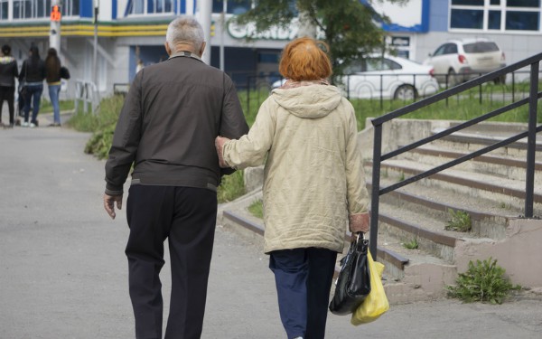 older couple walking down street