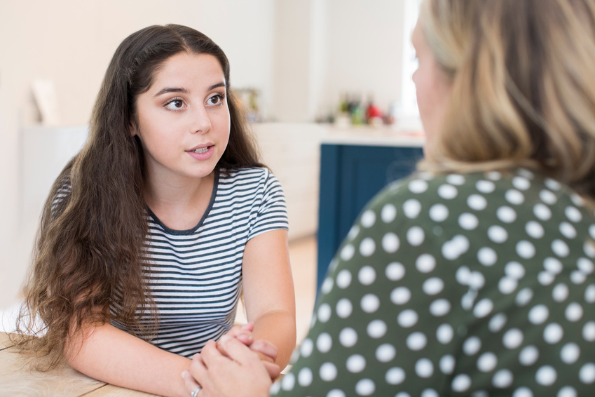 teenager and social worker having serious conversation