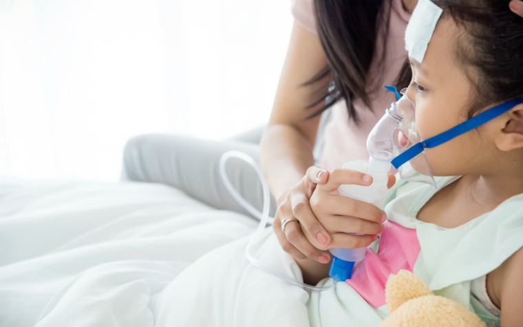 Young girl wearing oxygen mask