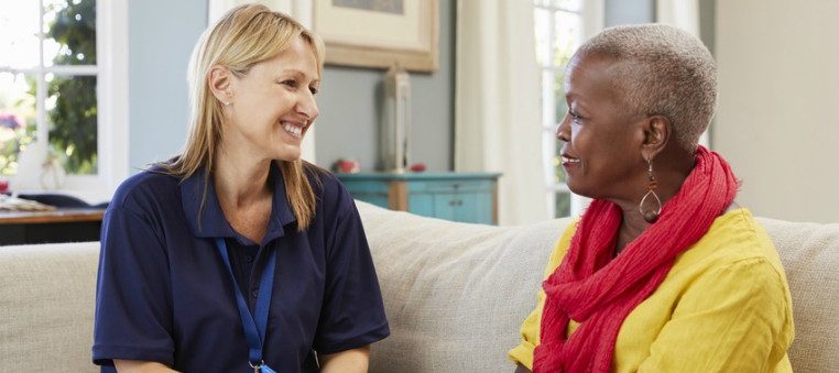 Female social worker visiting older person at home