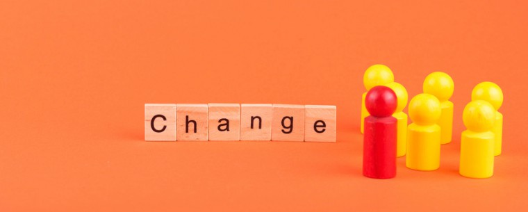 The word 'change' in wooden blocks and plastic figures