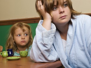 neglected child looking at distracted mother