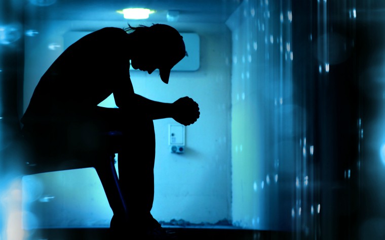 Silhouette of teenage boy, damged house/abstract