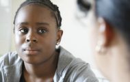 black teenage girl talking to social worker