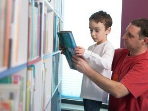 father and son choosing books in a contact centre
