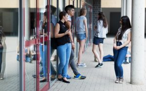 Teenagers outside school