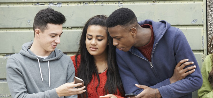 Group of teenagers looking at mobile phone