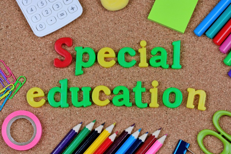 The words special education surrounded by pens, pencils and calculator