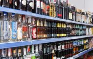 Rows of bottles of alcohol on supermarket shelves