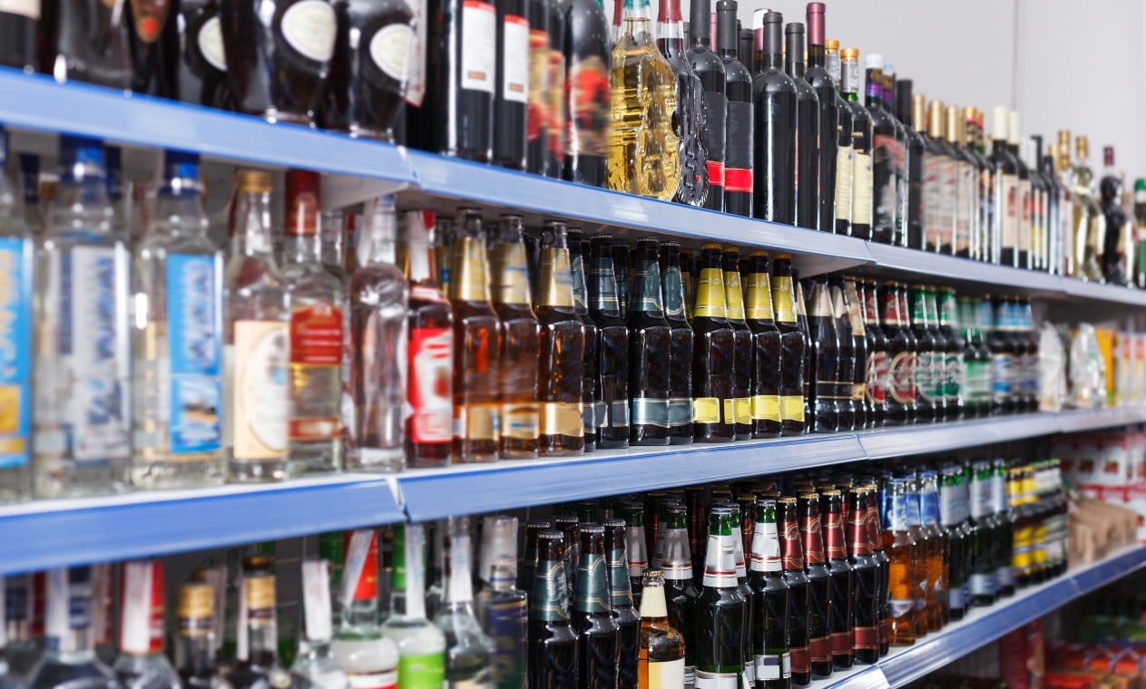 Rows of bottles of alcohol on supermarket shelves