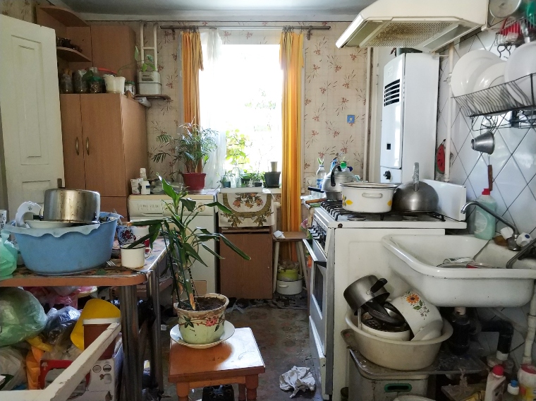 A kitchen full of pots and pans and other items