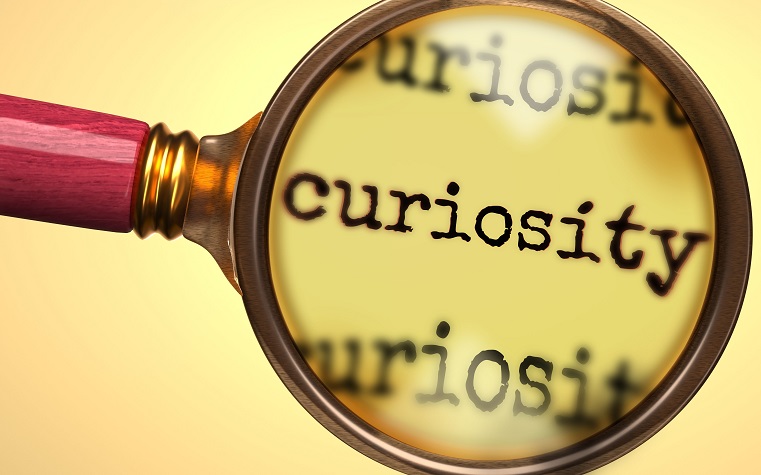 magnifying glass close-up on the word 'curiosity'