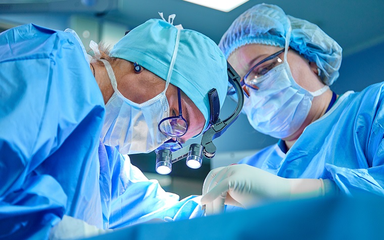 surgeons in scrubs performing an operation
