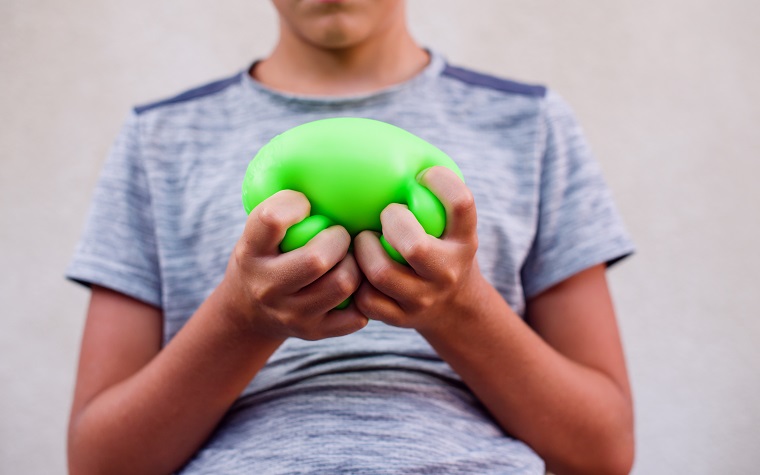child squeezing stress toy