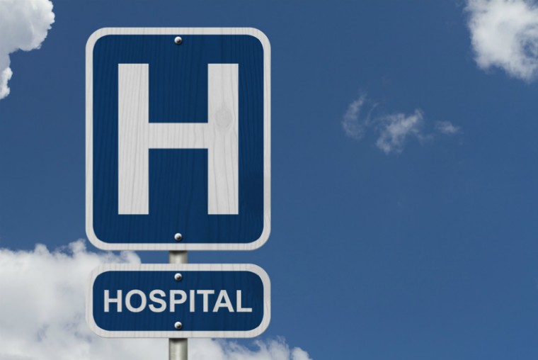 Hospital sign against blue sky
