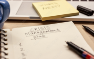'crisis management plan' written in a notebook