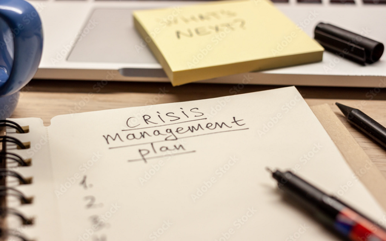 'crisis management plan' written in a notebook
