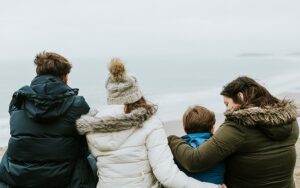 Back view of family at beach - contact