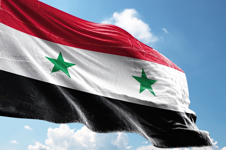 Syrian flag, tricoloured with red, white and black horizonal stripe and two green stars in the white stripe