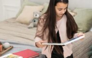 Teenage girl looking at photo books