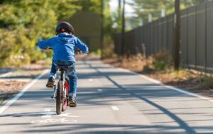 Australian boy riding his bicycle on bike lane on a day, South Australia