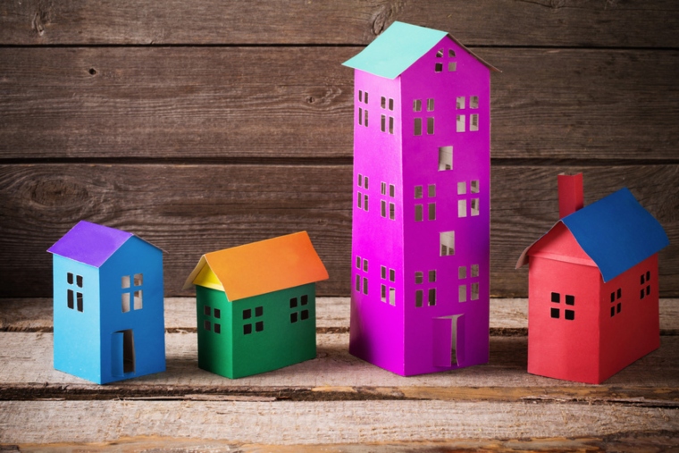 Colourful model houses of different sizes and one that looks like a block of flats