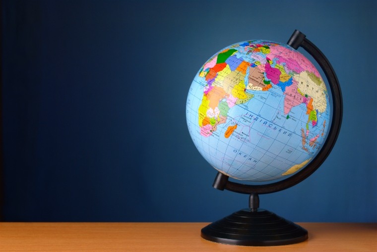 World globe on table with blue background