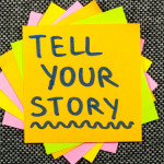 Stack of post-its with the text 'tell your story' on the top