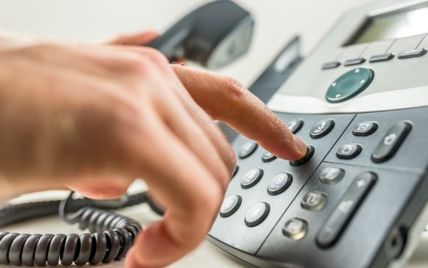 description_of_image_used_in_social_work_diary_hand_dialling_a_phone_Fotolia_Gajus_600x375