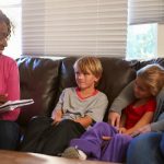 description_of_image_used_in_lambeth_social_work_piece_social_worker_talking_to_children_fotolia_monkey_business