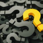 Yellow question mark amid pile of black ones