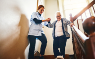 Care worker helping older person with mobility