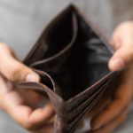 Image of empty wallet signifying poverty(Credit: vegefox / Adobe Stock)