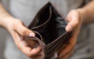 Image of empty wallet signifying poverty(Credit: vegefox / Adobe Stock)