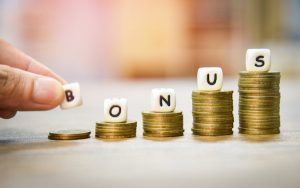 Image of the word 'bonus' on top of stacked coins
