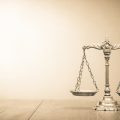 Image of scales of justice (credit: BrAt82 / Adobe Stock)