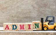 Image of forklift shifting barriers labelled 'admin' (Credit: bankrx / Adobe Stock)