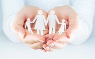 Image of cutouts representing family being held in hands (credit: Romolo Tavani / Adobe Stock)