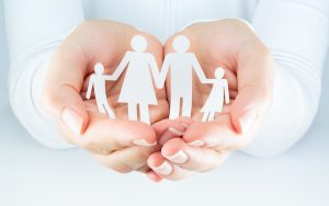 Image of cutouts representing family being held in hands (credit: Romolo Tavani / Adobe Stock)