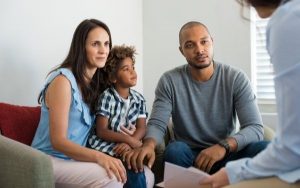 Family and child speaking to professional