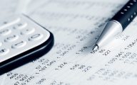 Image of accounts sheet with pen and calculator (credit: Wrangler / Adobe Stock)