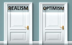 Image of two doors marked 'realism' and 'optimism' (credit: GoodIdeas / Adobe Stock)
