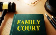 Image of book marked 'family court' and judge's gavel (credit: Vitalii Vodolazskyi / Adobe Stock)