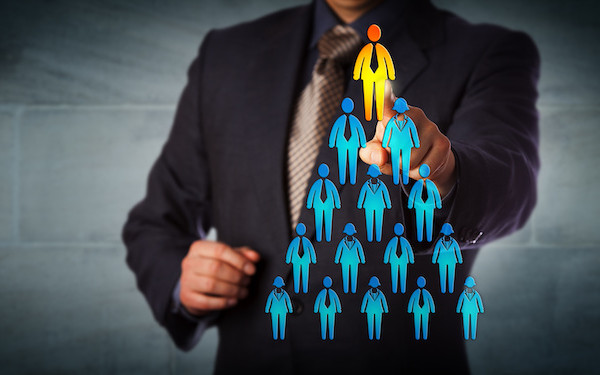 Image of person highlighted at top of employee hierarchy (credit: leowolfert / Adobe Stock)