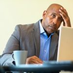 A Black social worker looking downcast